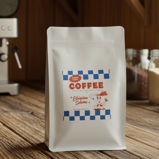 Coffee bag on a kitchen counter with a coffee maker and cup in the background