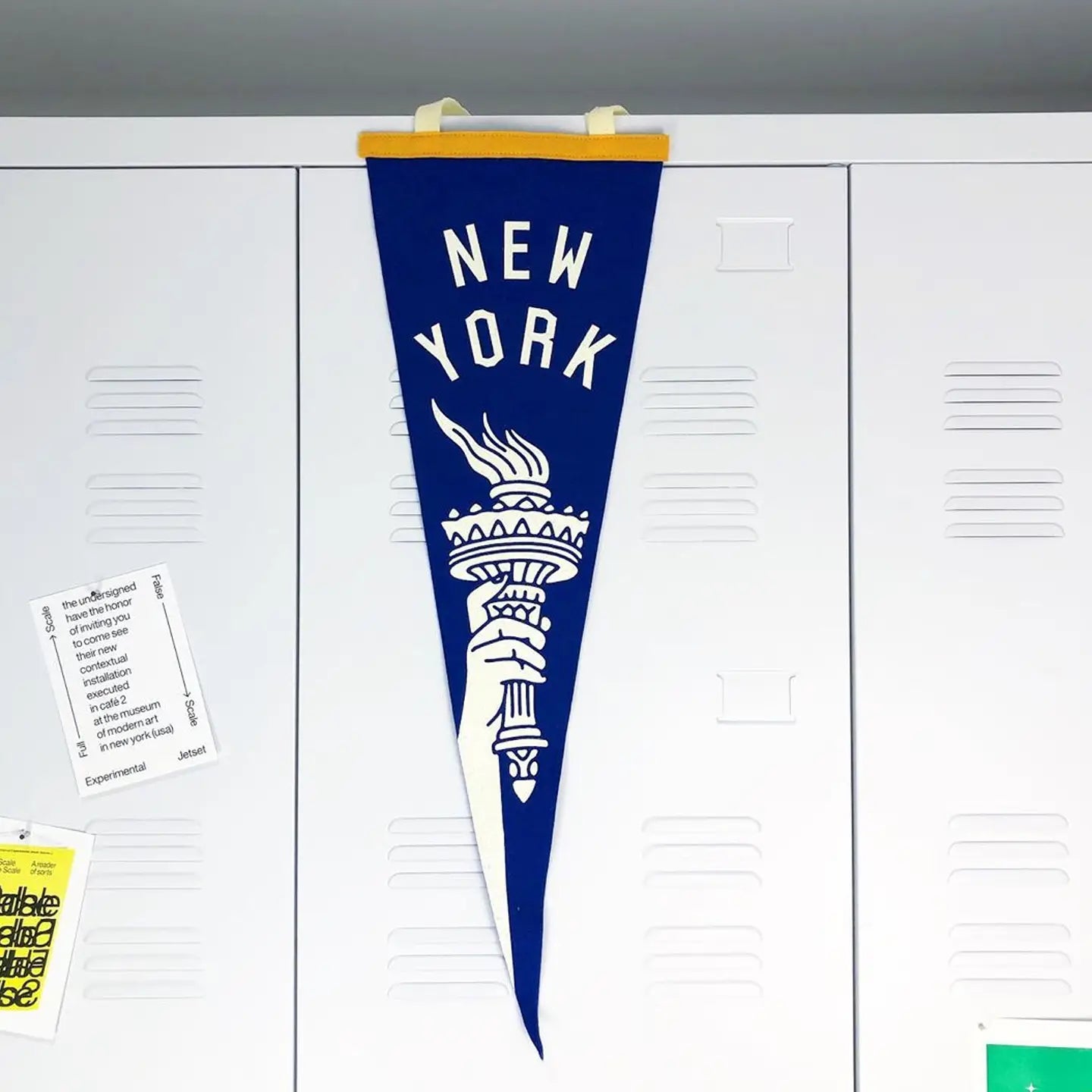 Blue New York-themed pennant hanging on a white locker door.
