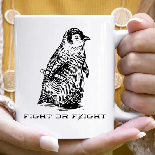 White mug with a black and white bird illustration and 'Fight or Flight' text held by hands.