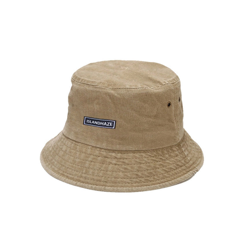 Khaki bucket hat with a brand label on a white background