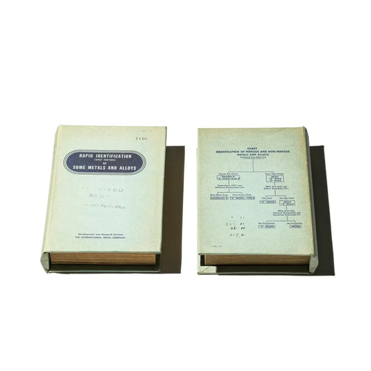 Two books on a stand with 'Metals and Alloys' text at the bottom.