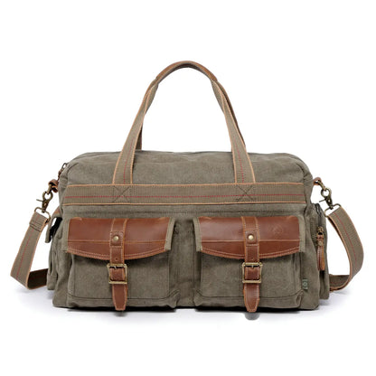 An olive green canvas duffel bag with brown leather accents, featuring two front utility pockets with buckle straps, dual top handles, and an adjustable shoulder strap, shown against a plain white background.